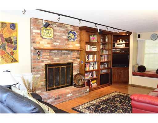 Family Room. Floor to ceiling fireplace, new hardwood flooring, built-in cases & window seat in the family room.