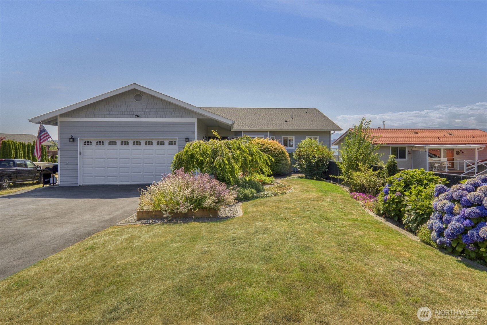 38291 Doe Road Northeast Hansville, WA 98340 - Photo 9 of 40 a front view of a house with a yard and garage
