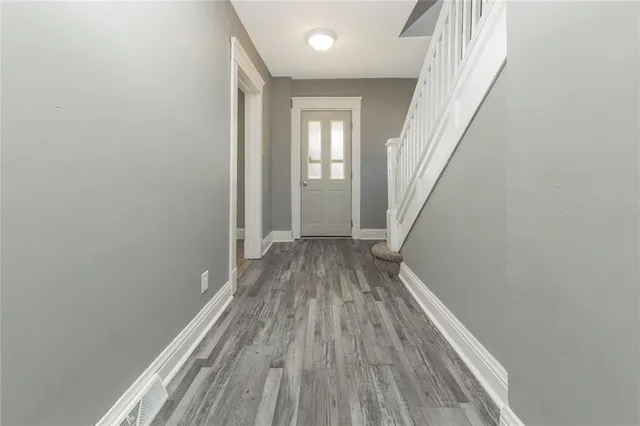 a view of a room with wooden floor and staircase