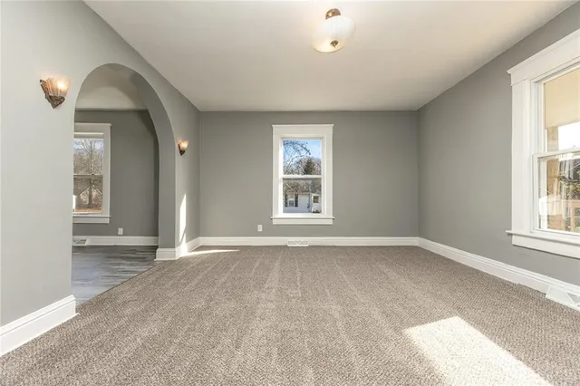 an empty room with windows and entrance