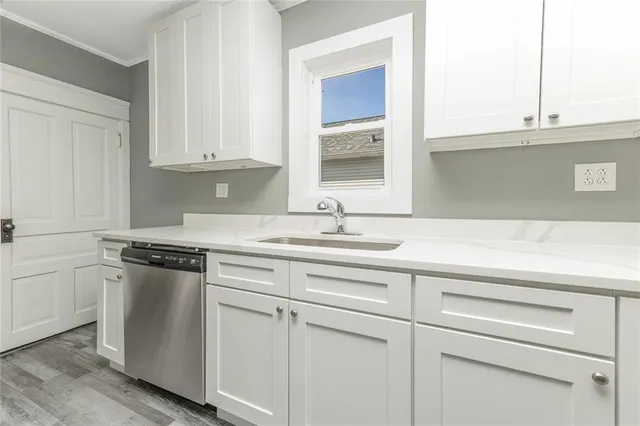 a kitchen with white cabinets and white appliances