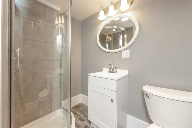 a bathroom with a sink toilet and shower