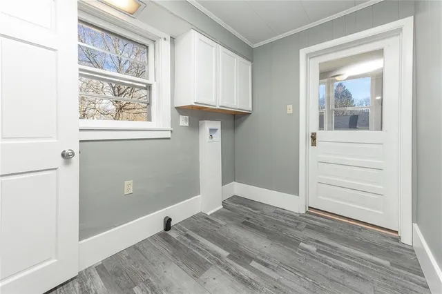 a view of a hallway with wooden floor and entryway