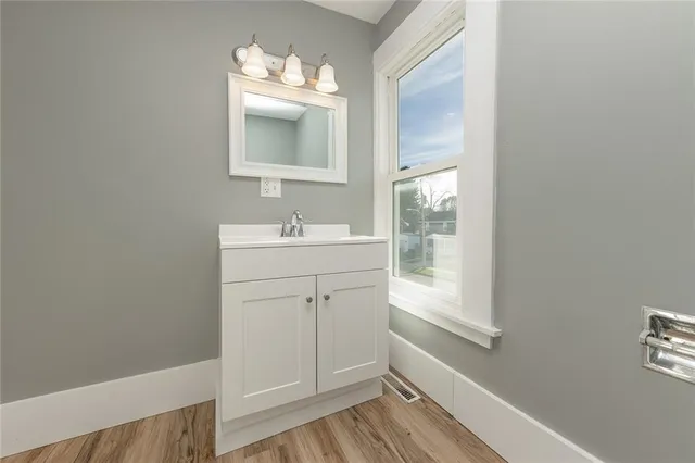 a bathroom with a sink mirror and vanity