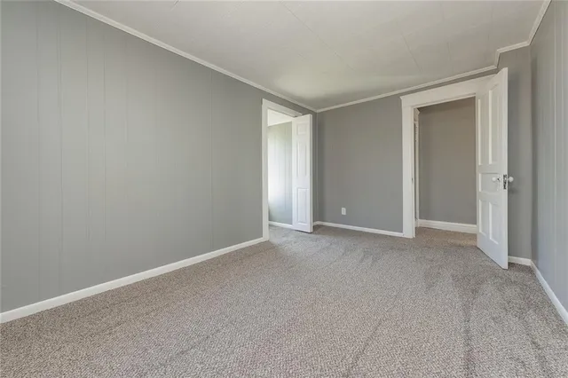 a view of an empty room and closet area