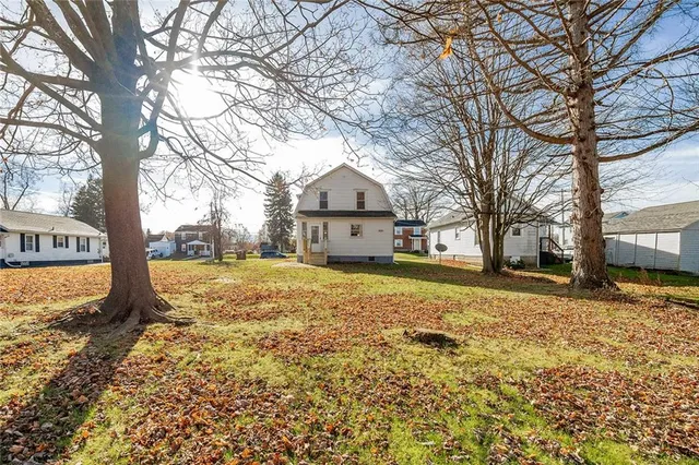 a large tree in front of a house