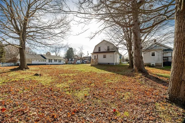 a view of a yard with a house and trees