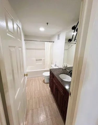 a bathroom with a sink a mirror a vanity and a shower