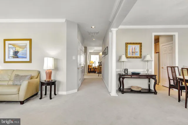 a dining room with furniture a chandelier and wooden floor