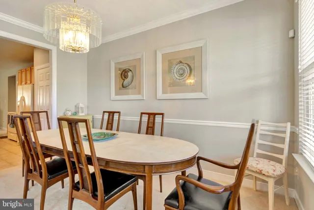 a living room with furniture kitchen view and a flat screen tv