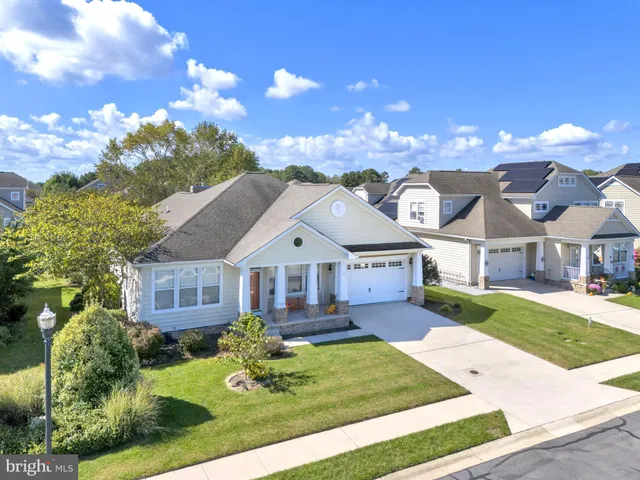 a front view of a house with yard and green space