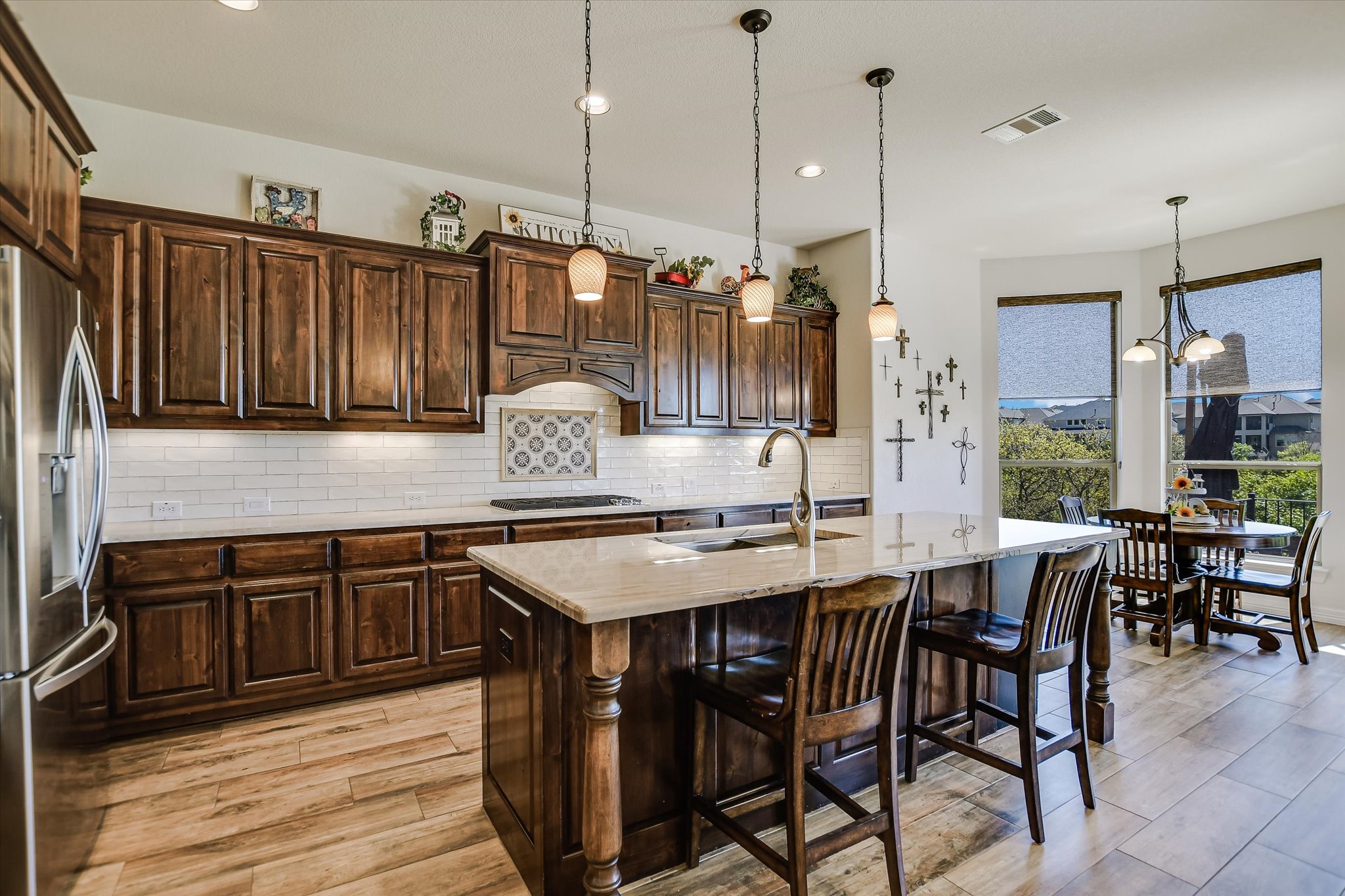 2404 First View Leander, TX 78641 - Photo 8 of 38 a kitchen with granite countertop a table chairs stove and cabinets
