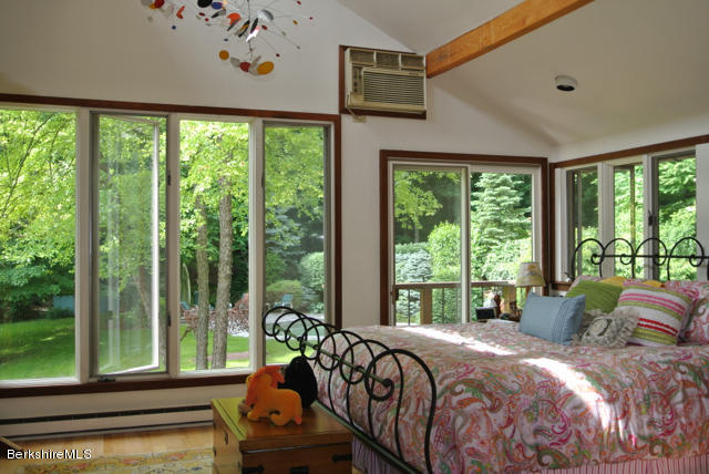 16 Averic Road Stockbridge, MA 01266 - Photo 11 of 24 a bed sitting in a bedroom next to a large window