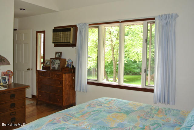 16 Averic Road Stockbridge, MA 01266 - Photo 14 of 24 a bedroom with a bed and a dresser in it