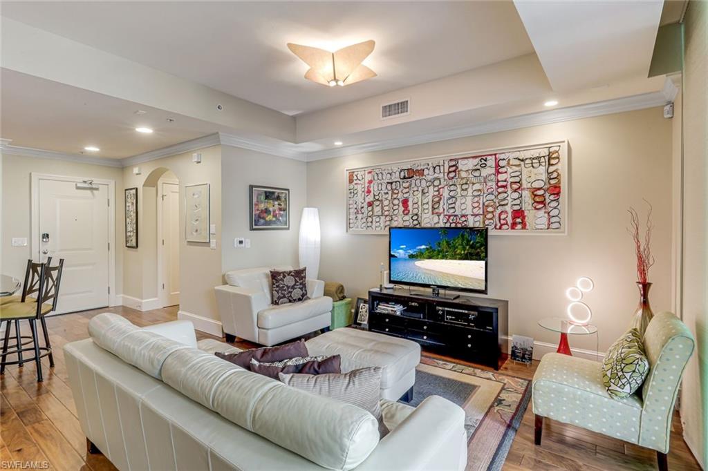 9123 Strada Place, Unit 7201 Naples, FL 34108 - Photo 4 of 50 a living room with furniture and a flat screen tv