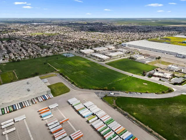 an aerial view of a house with a garden and lake view