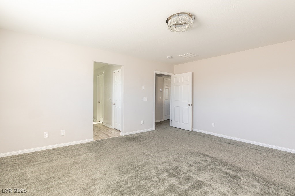 6856 Pivot Point Street Las Vegas, NV 89148 - Photo 22 of 32 Unfurnished bedroom featuring light colored carpet and baseboards