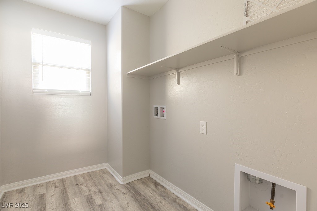 6856 Pivot Point Street Las Vegas, NV 89148 - Photo 25 of 32 Laundry area featuring washer hookup and light wood-type flooring