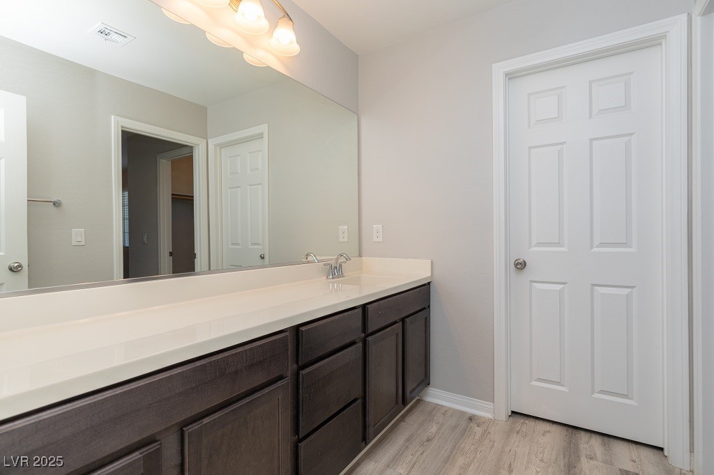 6856 Pivot Point Street Las Vegas, NV 89148 - Photo 28 of 32 Bathroom with light wood-style floors and vanity