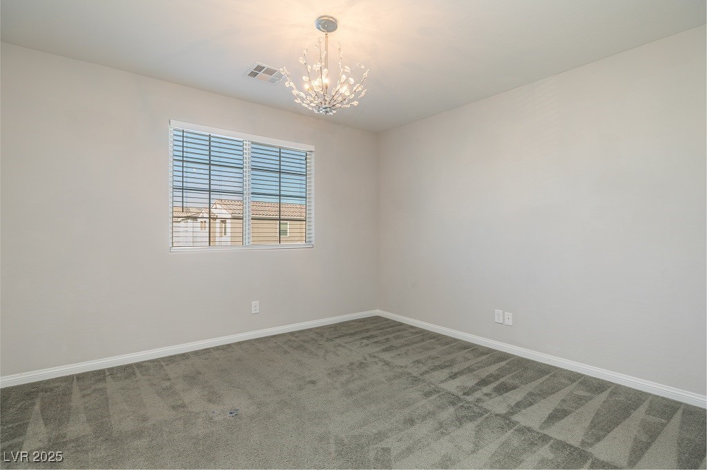6856 Pivot Point Street Las Vegas, NV 89148 - Photo 30 of 32 Empty room with carpet floors and a chandelier