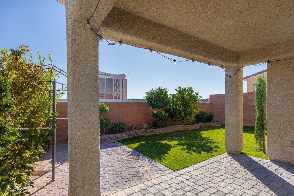 6856 Pivot Point Street Las Vegas, NV 89148 - Photo 5 of 32 Fenced backyard with a patio area