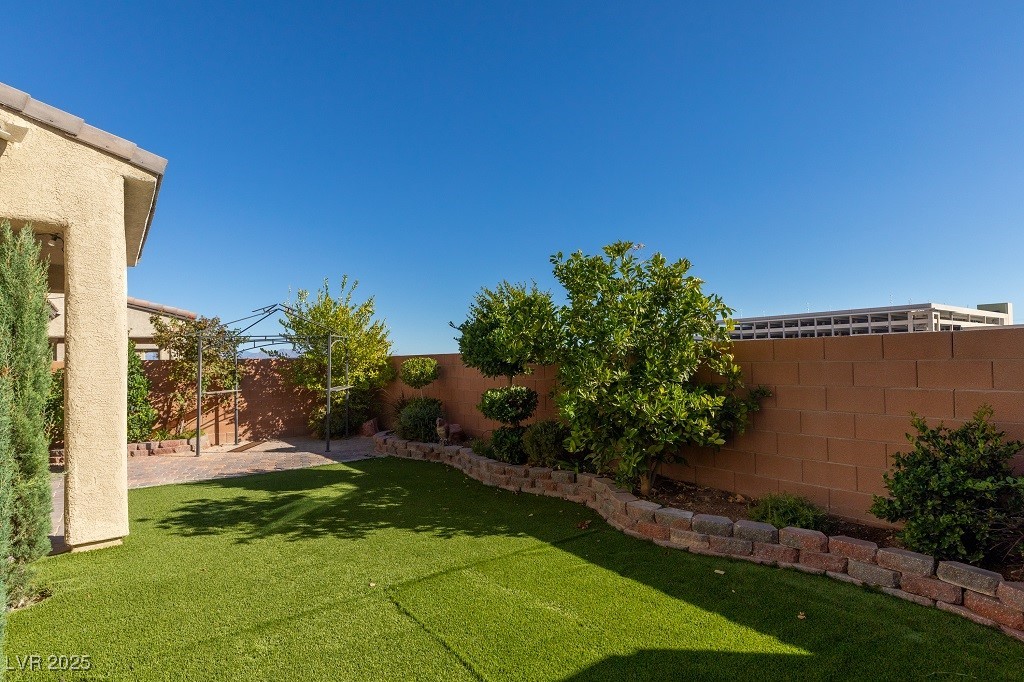6856 Pivot Point Street Las Vegas, NV 89148 - Photo 7 of 32 Fenced backyard with a patio
