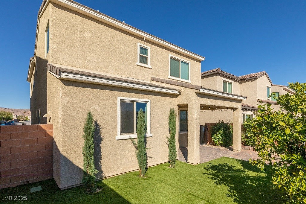 6856 Pivot Point Street Las Vegas, NV 89148 - Photo 8 of 32 Back of house featuring a patio area and stucco siding