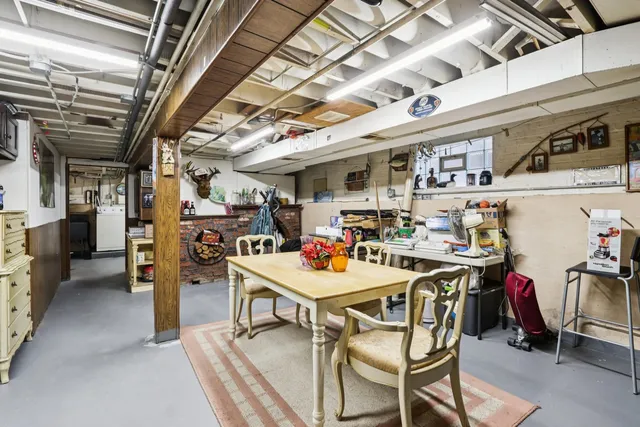 a view of a dining room with furniture a kitchen and chandelier