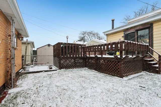 a view of a house with wooden fence
