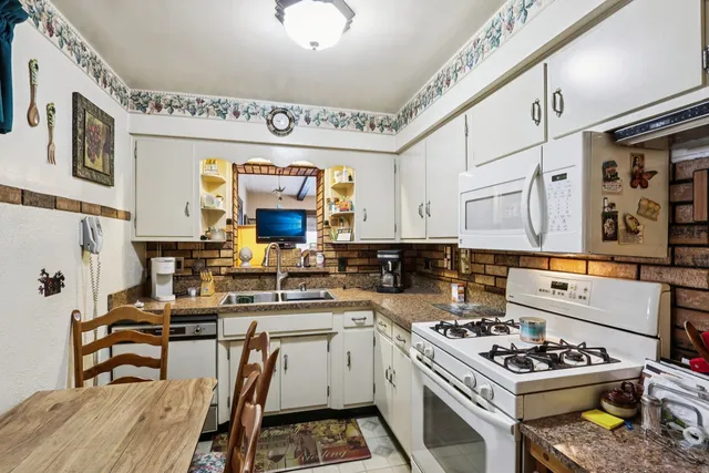 a kitchen with a stove a sink and a refrigerator