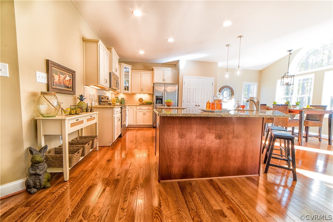 10819 Avening Road Chesterfield, VA 23832 - Photo 9 of 32 a living room with stainless steel appliances furniture wooden floor and a kitchen view