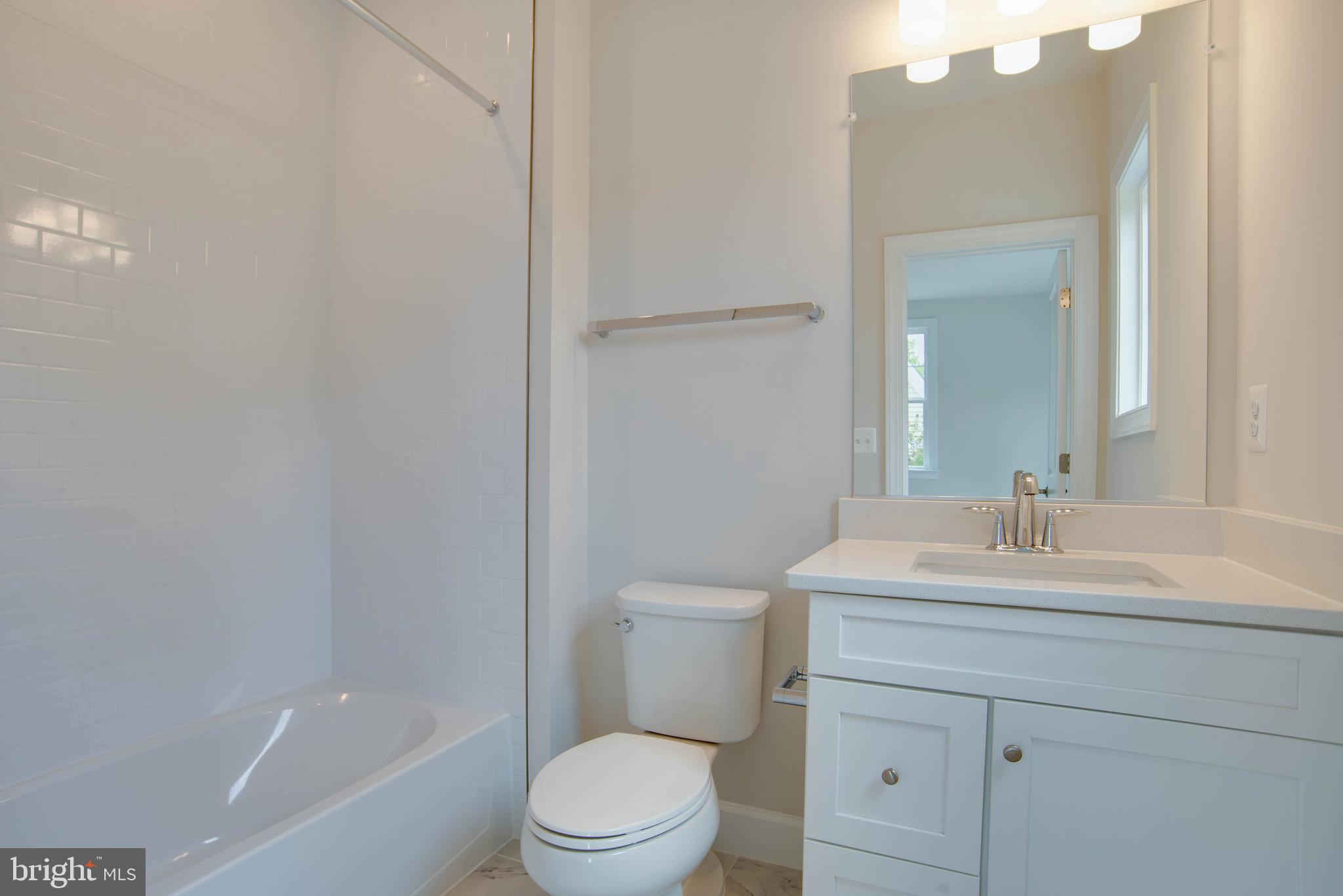 1419 Cottage Street Southwest Vienna, VA 22180 - Photo 23 of 34 a bathroom with a sink a toilet and shower