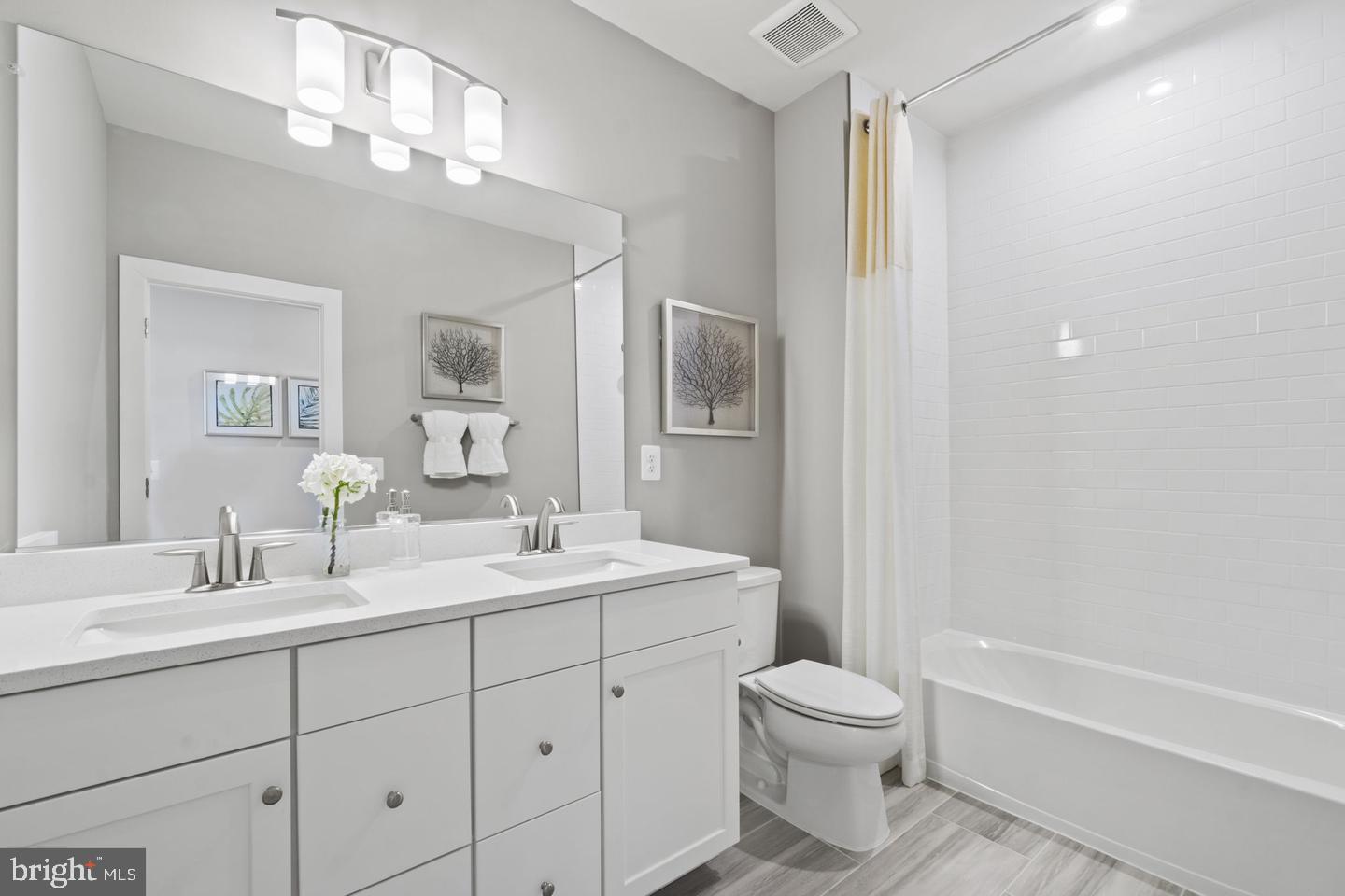 1419 Cottage Street Southwest Vienna, VA 22180 - Photo 25 of 34 a bathroom with a toilet a sink a mirror a bathtub and vanity