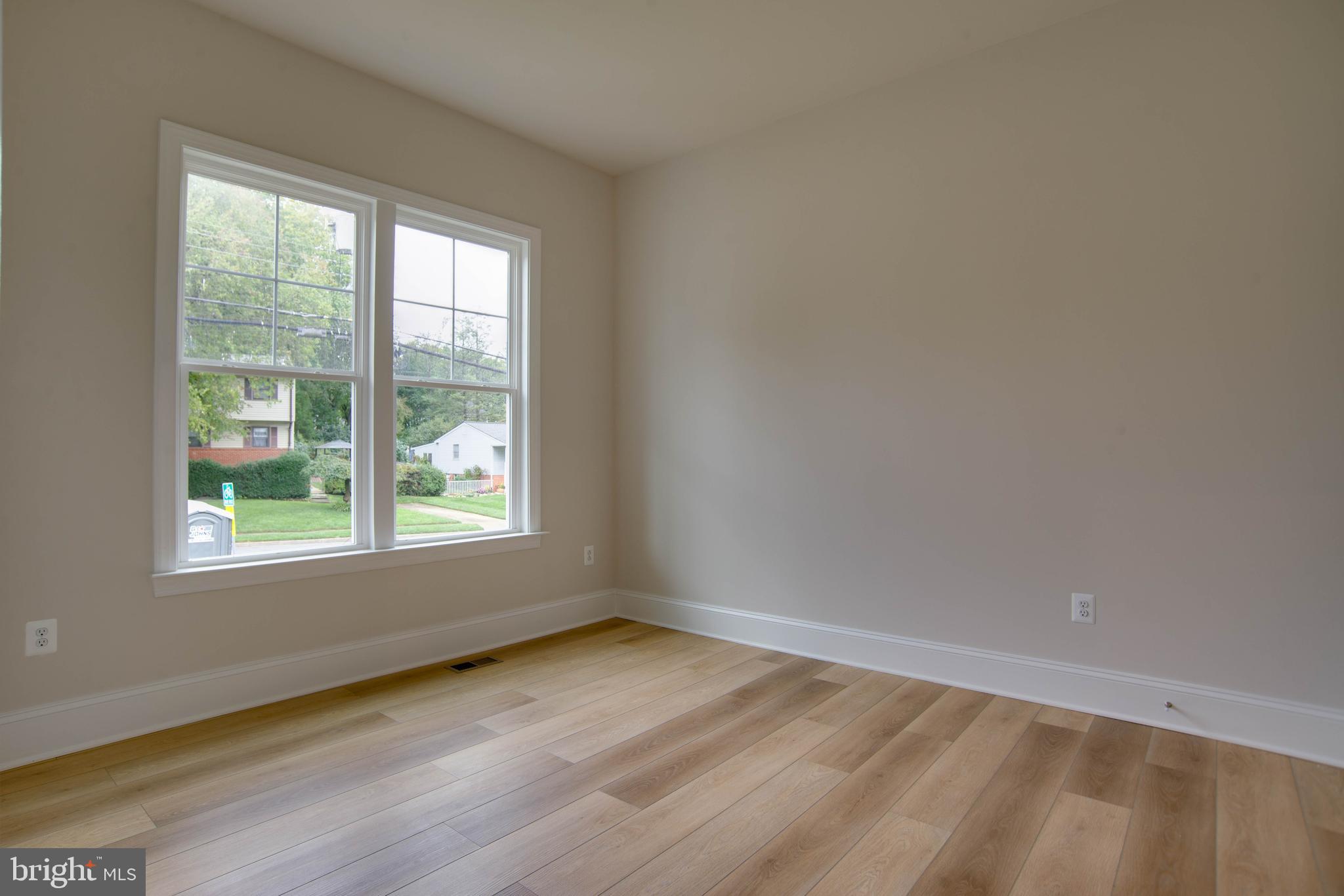 1419 Cottage Street Southwest Vienna, VA 22180 - Photo 3 of 34 an empty room with wooden floor and windows