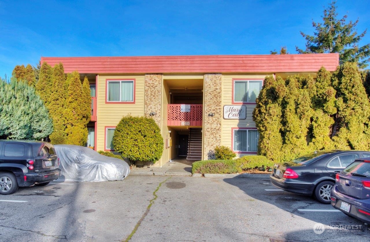 a front view of a house with parking space