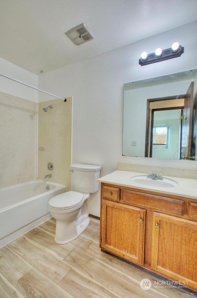 440 Southwest 155th Street Burien, WA 98166 - Photo 11 of 22 a bathroom with a toilet a sink a mirror and bathtub