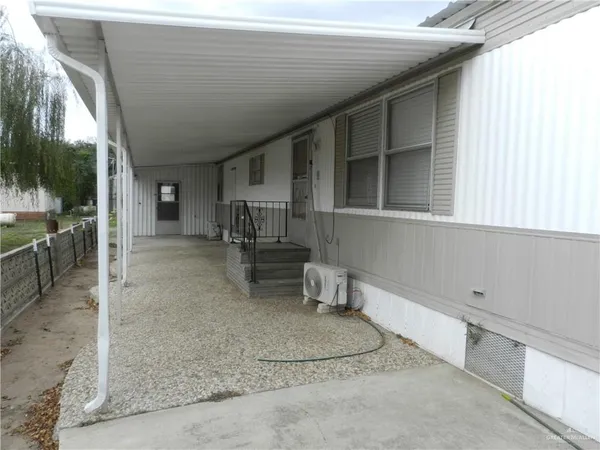 a view of a patio with table and chairs and wooden fence