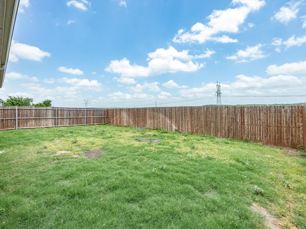 1121 Knightsbridge Road Argyle, TX 76226 - Photo 36 of 39 Expansive grassy backyard featuring a full privacy fence