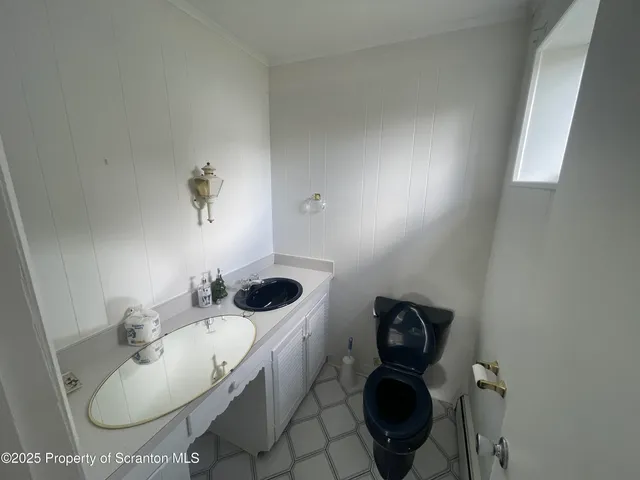 a bathroom with a sink toilet and a mirror