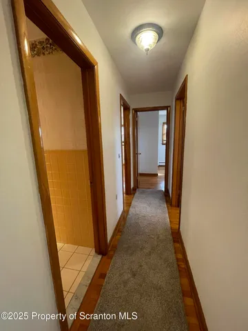 a view of hallway with stairs and a door