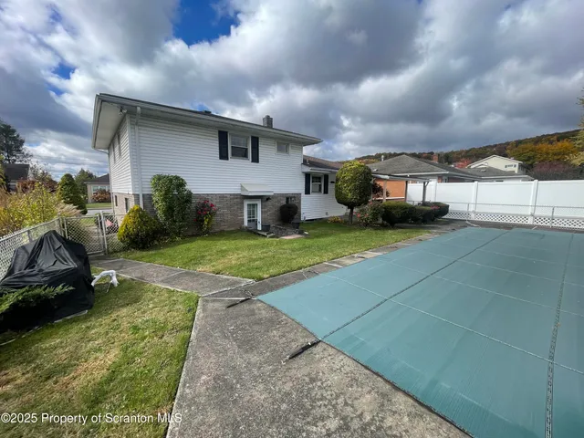 a view of a house with backyard and porch