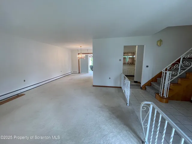 a view of an empty room with stairs