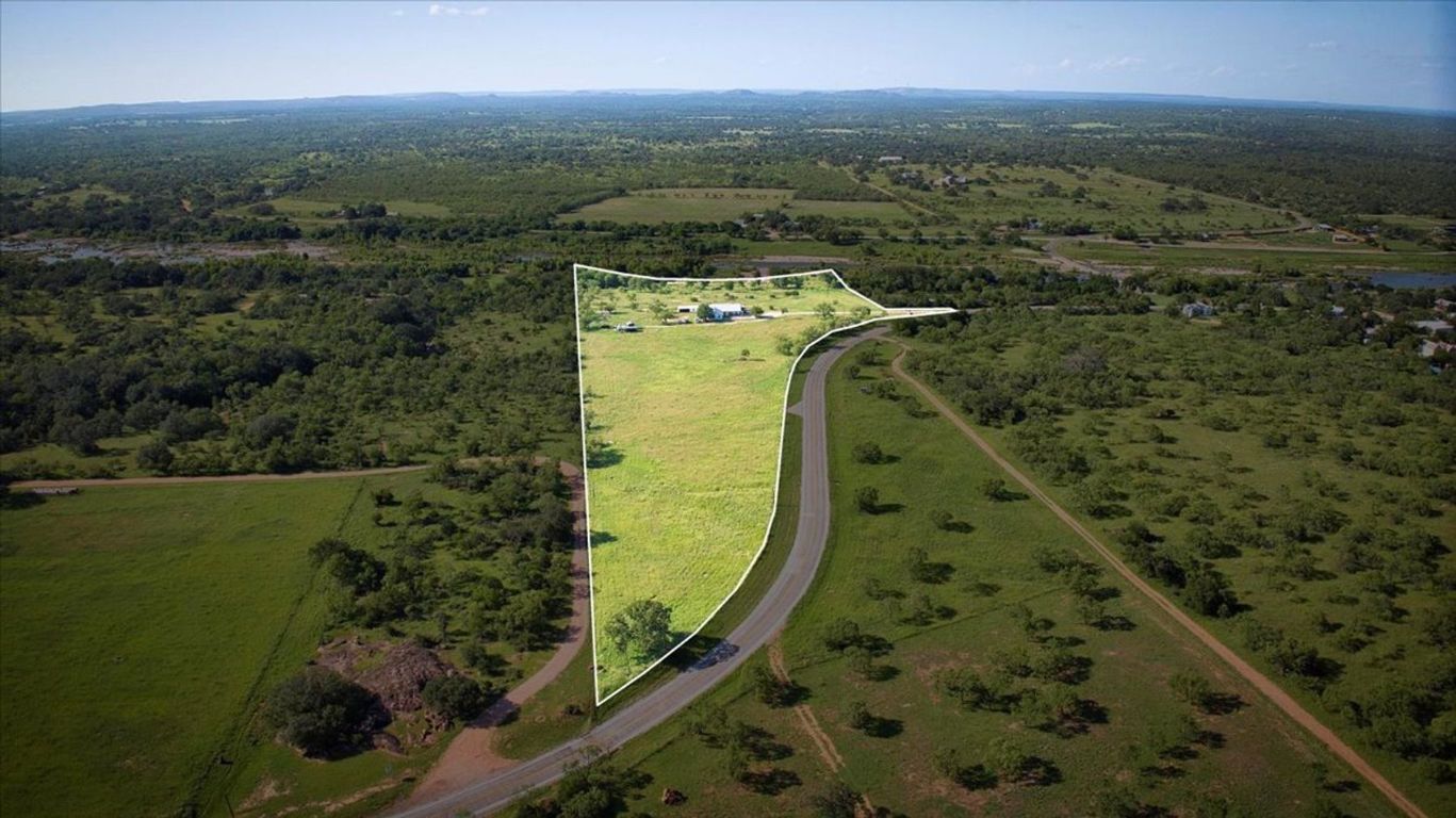 19811 West Ranch Road 152 Llano, TX 78643 - Photo 13 of 38 Aerial view of property and surrounding area featuring property boundaries highlighted and a heavily wooded area