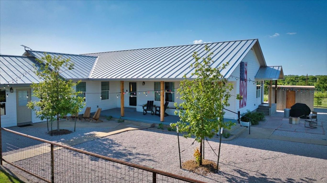 19811 West Ranch Road 152 Llano, TX 78643 - Photo 16 of 38 View of front of home featuring a standing seam roof, a metal roof, and a patio