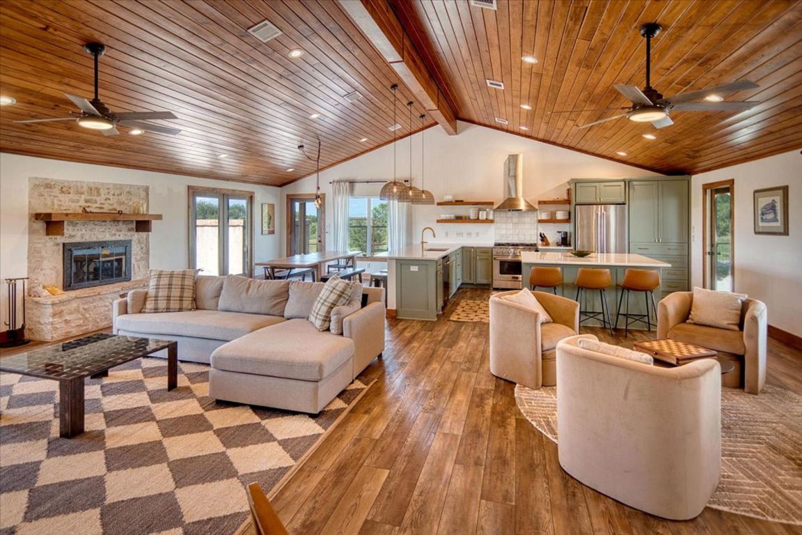 19811 West Ranch Road 152 Llano, TX 78643 - Photo 24 of 38 Living room with ceiling fan, wood ceiling, hardwood / wood-style floors, a fireplace, and recessed lighting