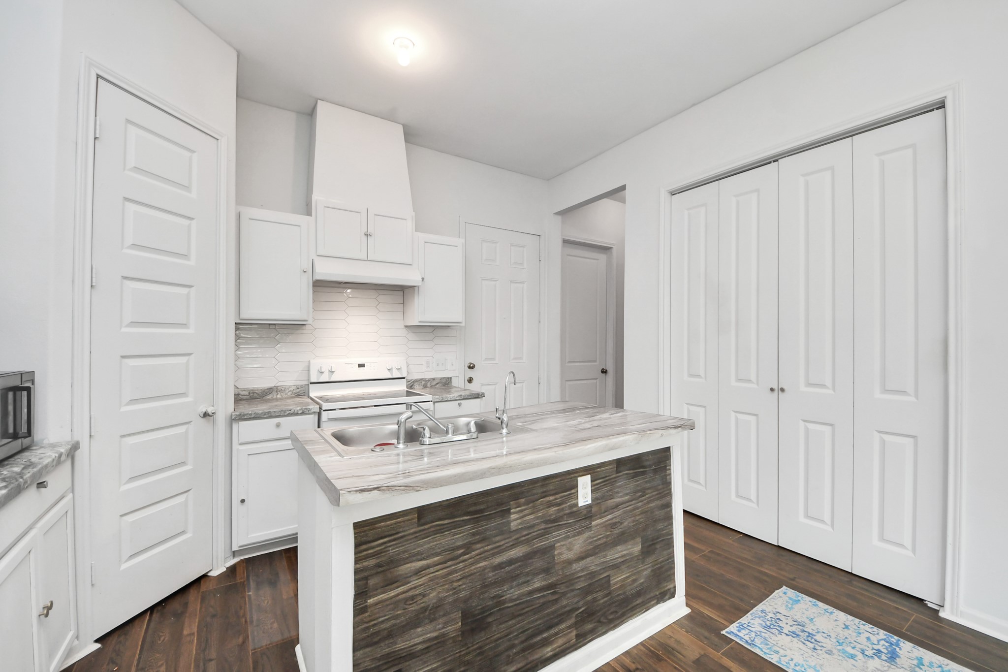 3011 Layne Street La Porte, TX 77571 - Photo 19 of 41 a kitchen with stainless steel appliances white cabinets and a sink