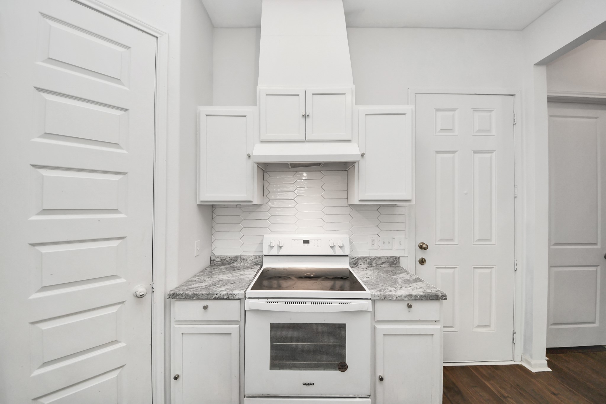 3011 Layne Street La Porte, TX 77571 - Photo 23 of 41 a kitchen with white cabinets and white stove