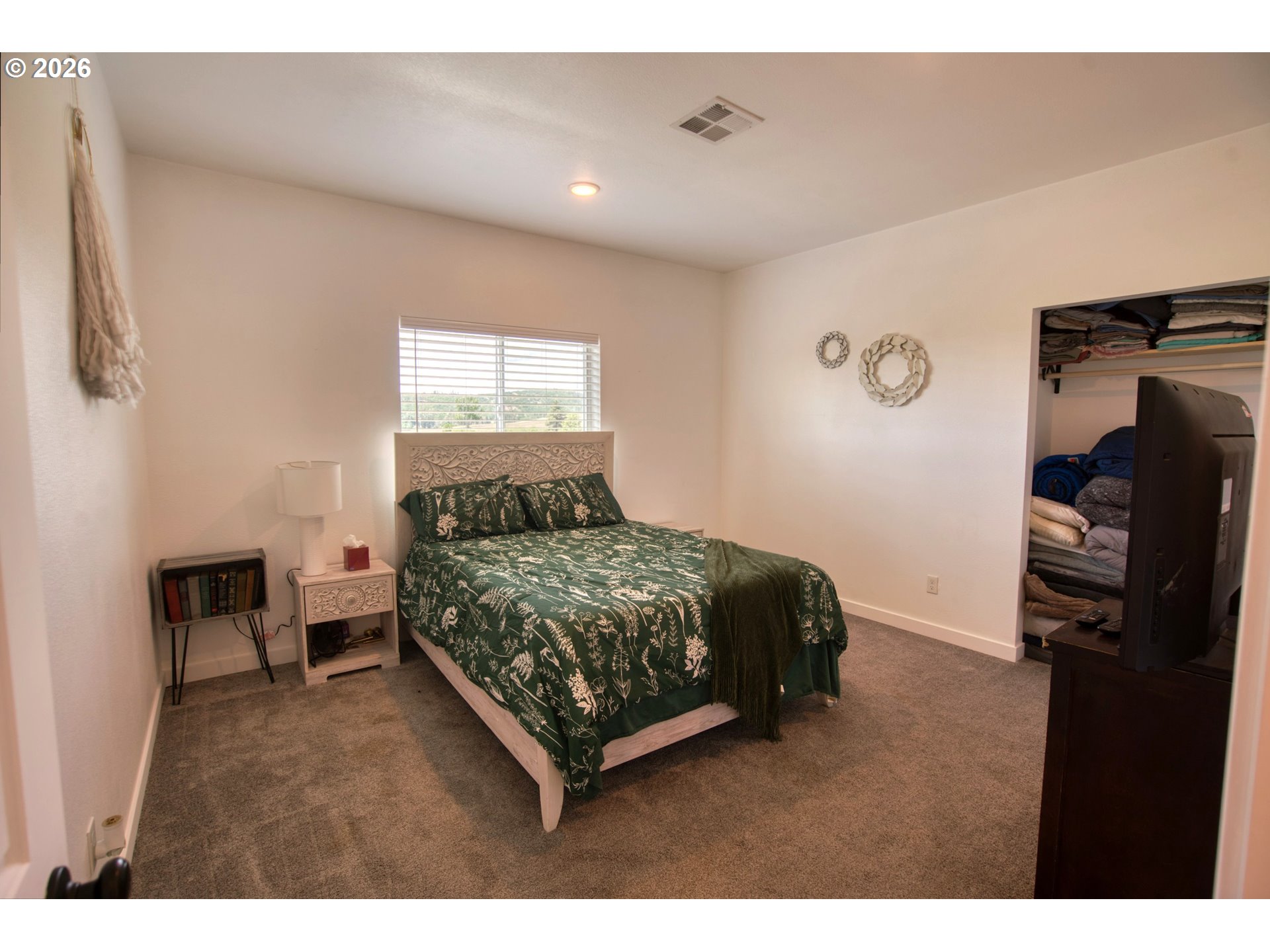 19 Inverness Road Goldendale, WA 98620 - Photo 30 of 48 a bedroom with a bed and a walk in closet