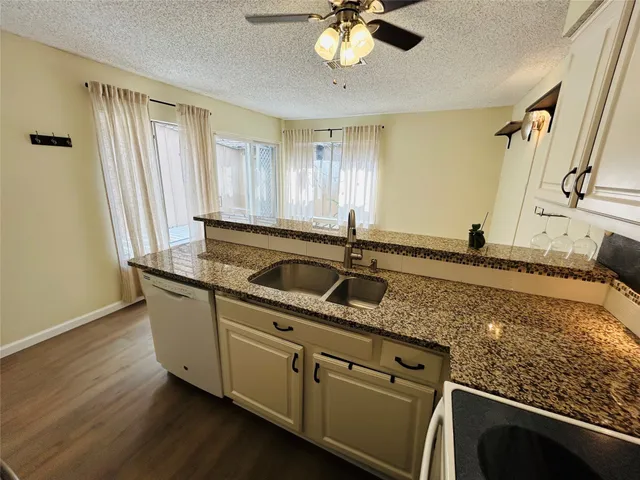 a kitchen with stainless steel appliances granite countertop a sink and a granite counter tops