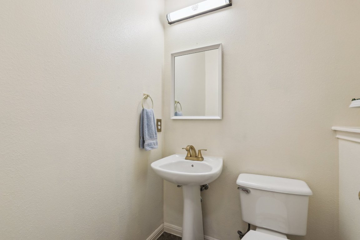 3805 Pebble Court Round Rock, TX 78664 - Photo 11 of 31 a bathroom with a sink a toilet and mirror
